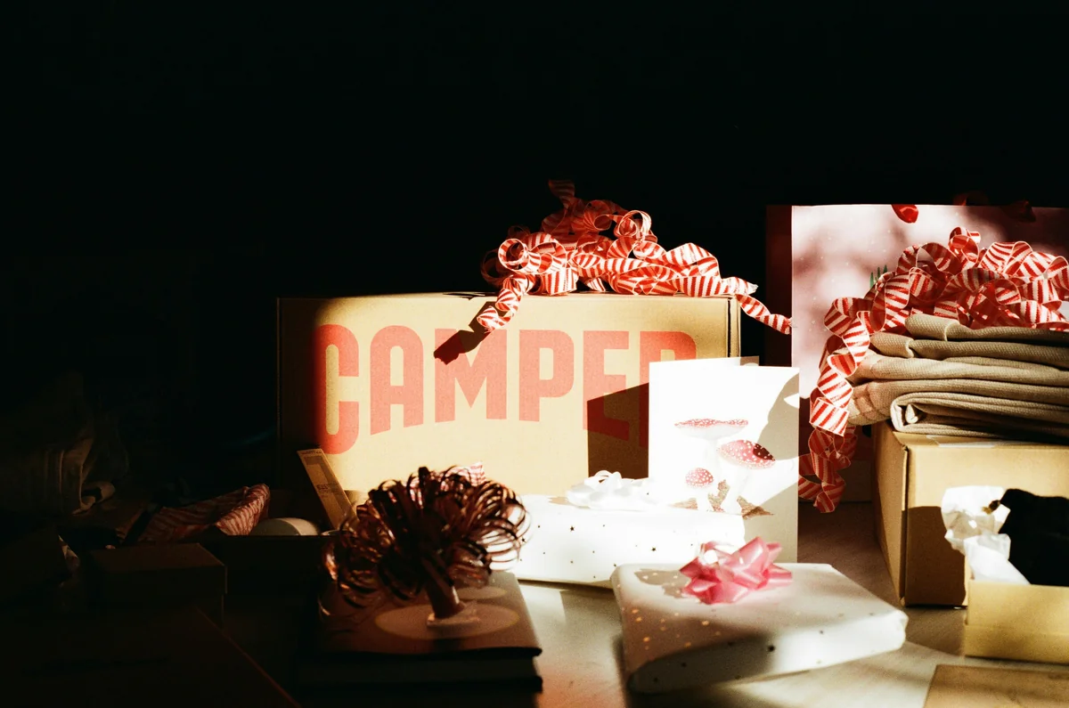 A Camper shoe box among other festively-wrapped Christmas gifts