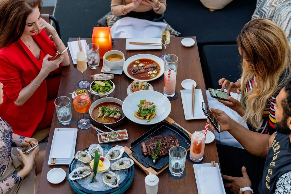 Friends enjoying a gourmet meal together in a Dubai restaurant.