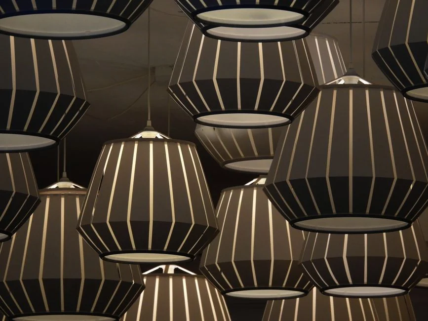 Chic arrangement of black and white geometric pendant lights creating an artistic ceiling display.