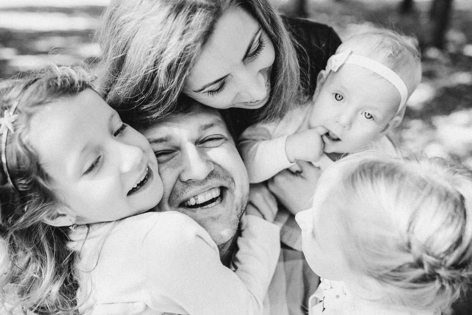A happy family shares a warm embrace, expressing love and togetherness.